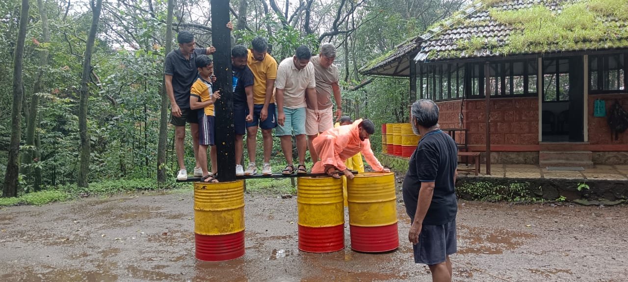 Team navigating an outdoor obstacle course exercise