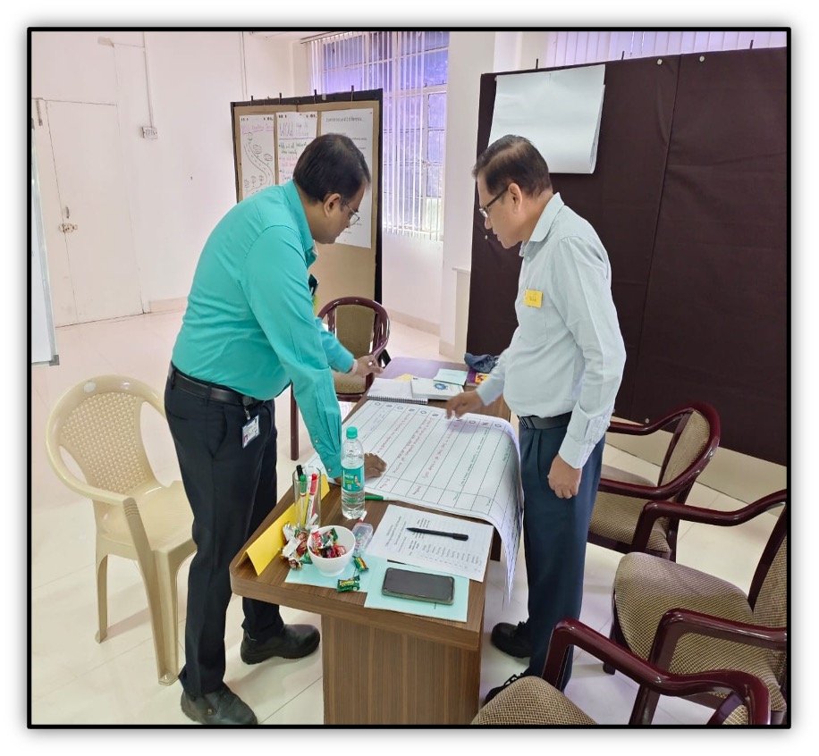 Two colleagues reviewing a needs and offers sheet together