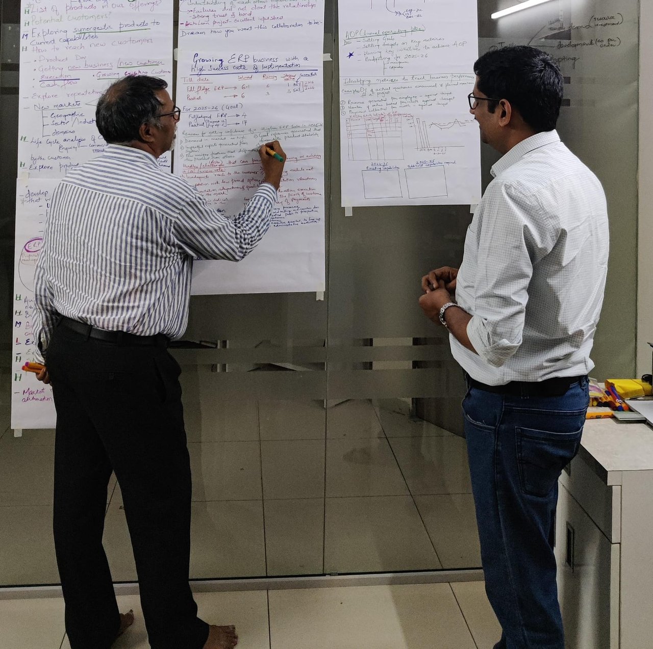 Office signage reading EnggDesign during a team discussion