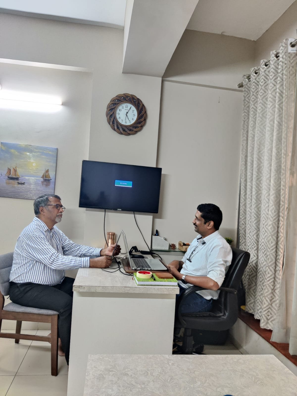 Two leaders in a follow-up meeting reviewing progress