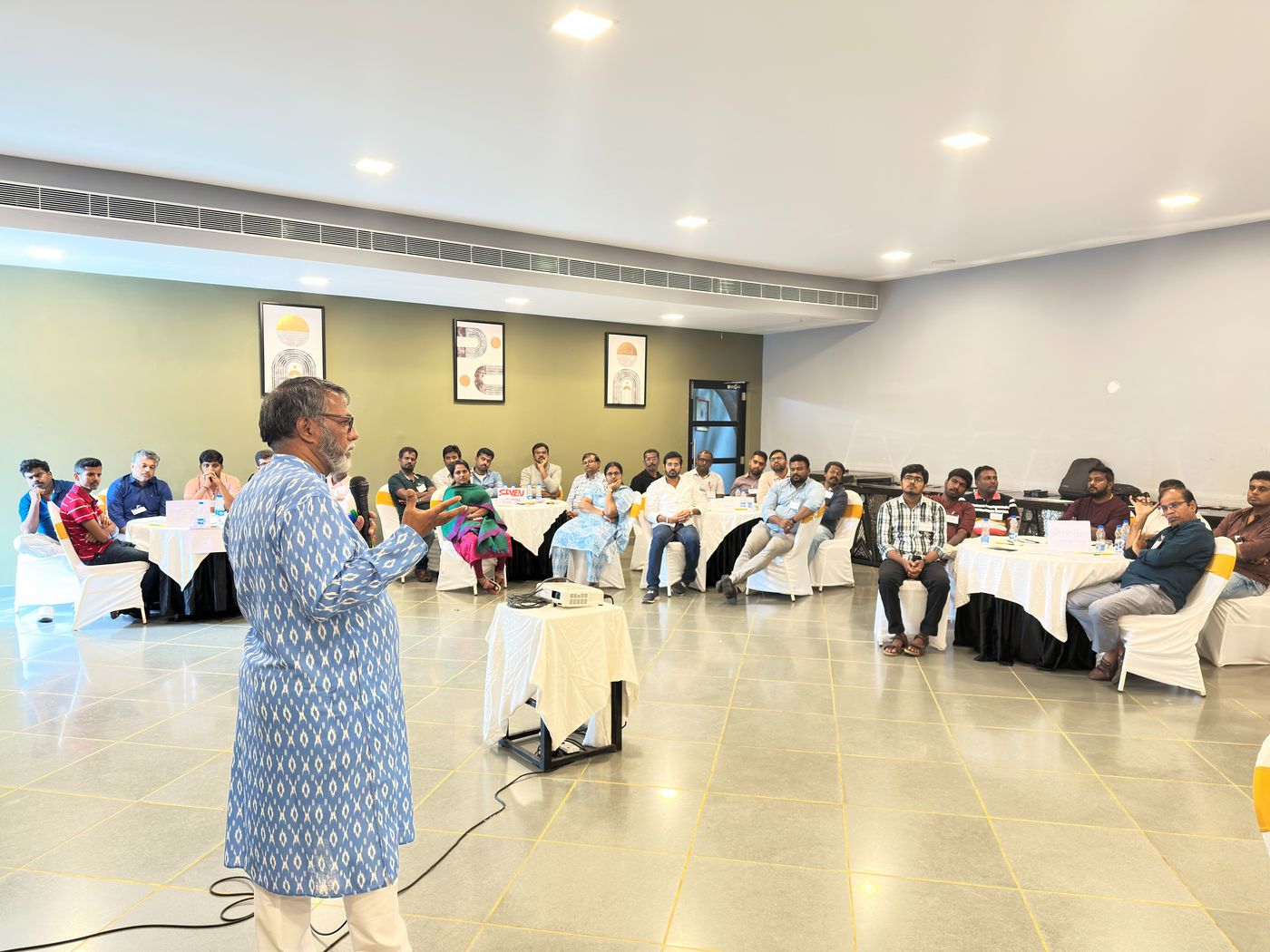 Pawankumar addressing a full room during a workshop