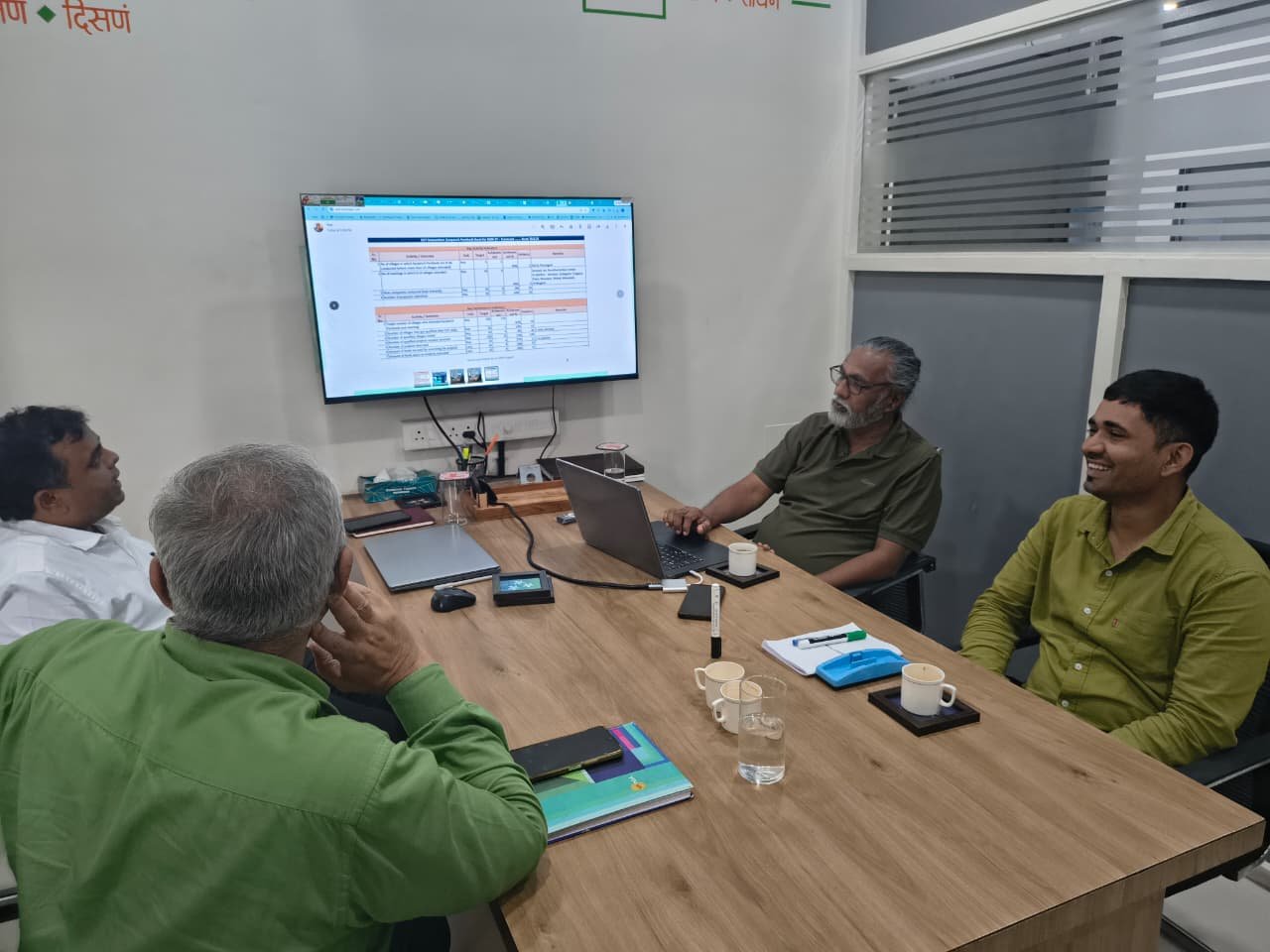 NGO leadership team reviewing progress dashboards together