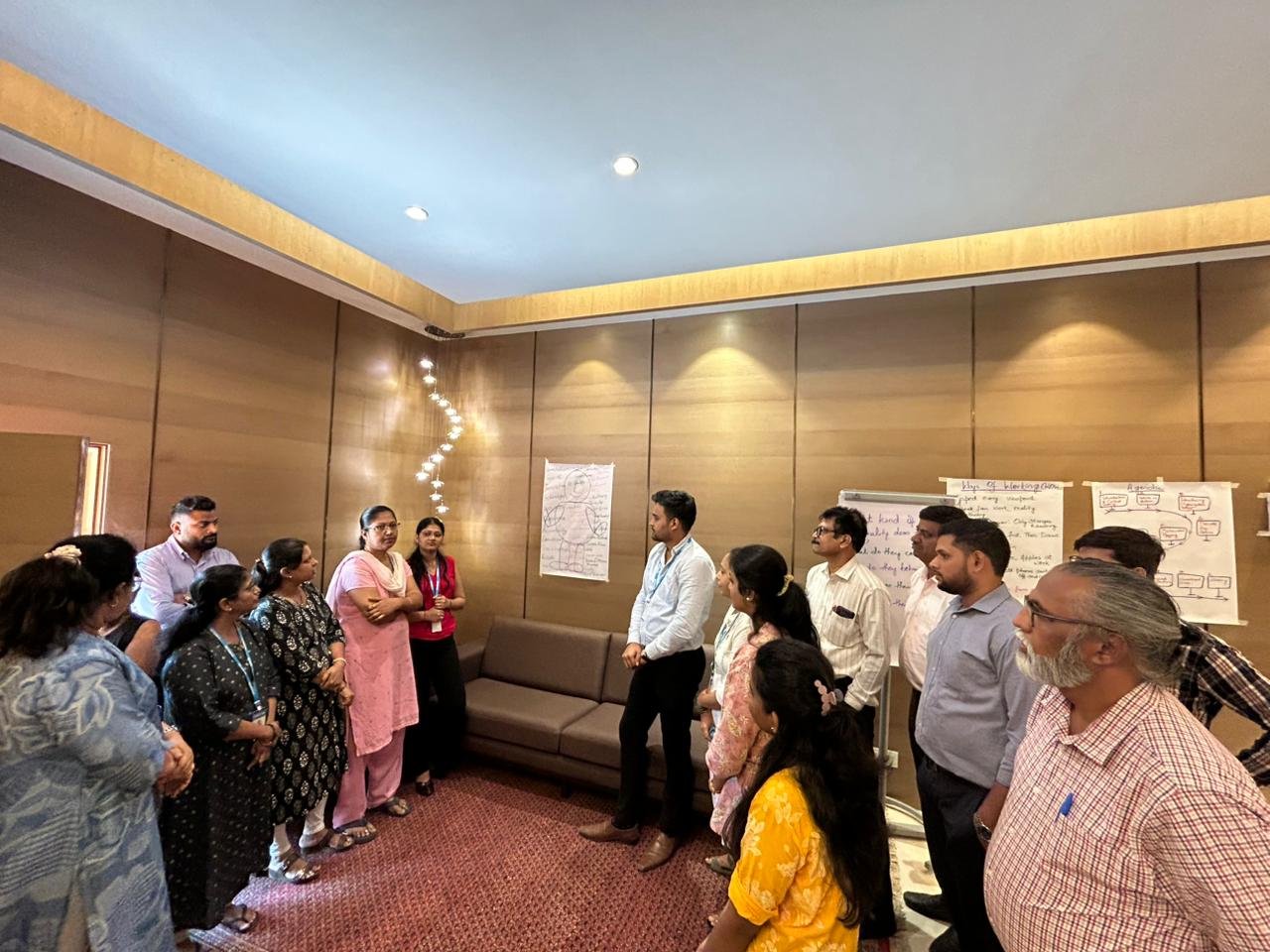 Team gathered around flipcharts working through the strategy architecture