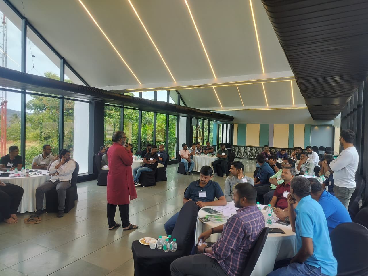 Large group seated for a learning session in a seminar hall