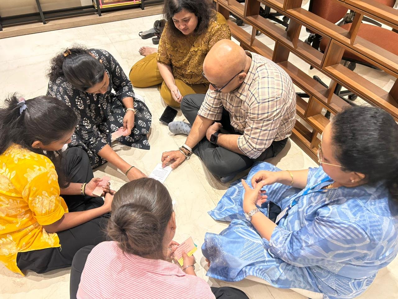Colleagues exchanging notes during a values discussion exercise