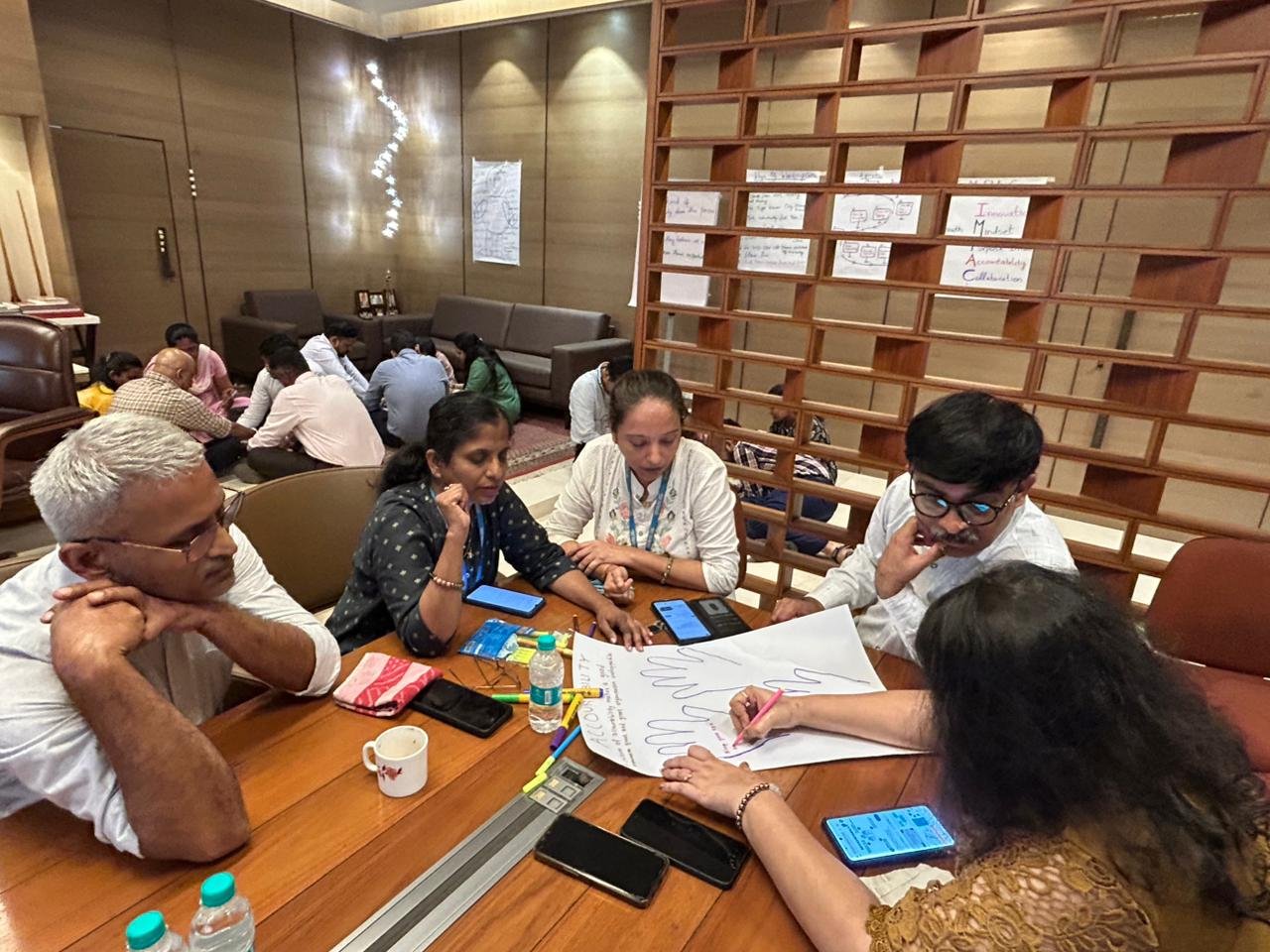 Facilitator leading a participant-led reflection exercise on a flipchart